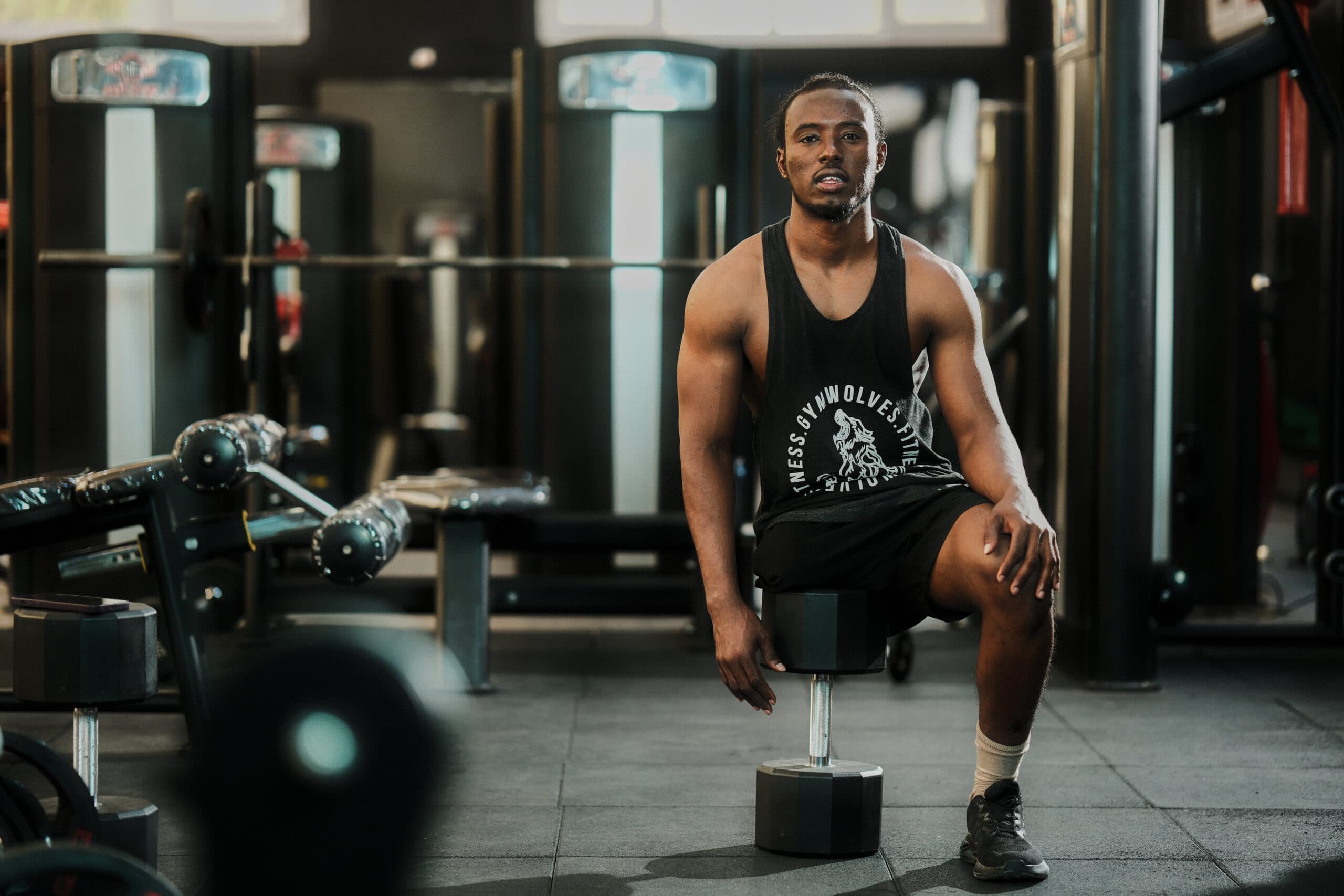 Coach Ali seated in the gym before training.